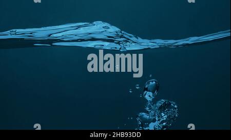 Soda water bubble splashing and floating drop. Represent sparkling and refreshing. Close up soda water bubbles floating up to top of water surface on Stock Photo