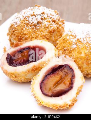 Plum dumplings on a white plate Stock Photo