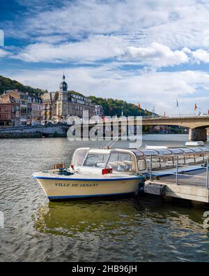 Dinant, Belgium - October 10 2019: Boat on the River Meuse with cityscape Stock Photo