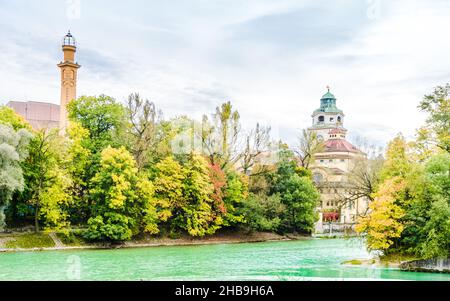 View on Colorful autumn landscape in front of Mueller Volksbad of Isar river - Munich Stock Photo