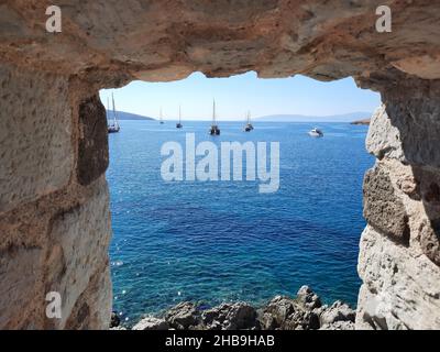 Sea view with yachts through the wall of St. Peter's Castle in Bodrum. Turkey. Stock Photo