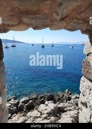 Sea view with yachts through the wall of St. Peter's Castle in Bodrum. Turkey. Stock Photo