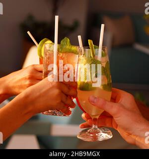 a group of people enjoying cocktail party with cheers hands Stock Photo