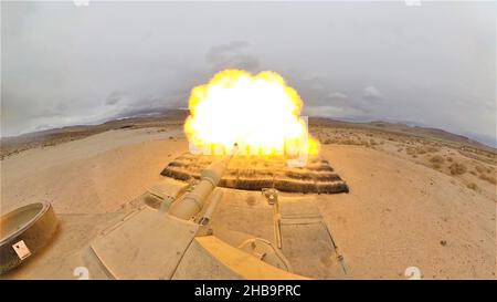 An M1A2 Abrams SEP V2 main battle tank, assigned to Cold Steel Troop, 1st Squadron, 11th Armored Cavalry Regiment, fires a M865 target practice cone stabilized discarding sabot with tracer on December 9, 2021, at the National Training Center and Fort Irwin training area. Stock Photo