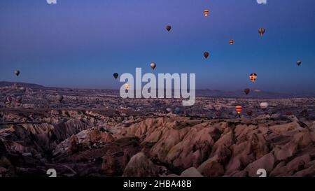 GOREME, CAPPADOCIA, TURKEY - November 12, 2021: The great tourist attraction of Cappadocia - balloon flight. Stock Photo