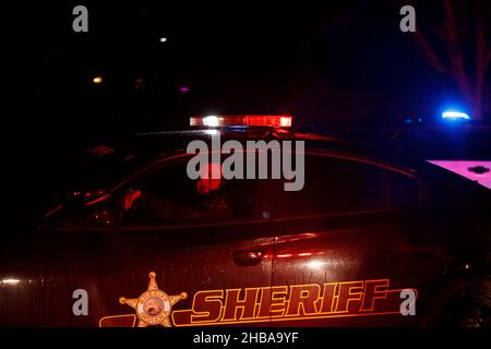 Bloomington, United States. 17th Dec, 2021. A deputy sheriff leaves W. Tower Road after a fatal plane crash around 8:15 p.m. in Bloomington.The Indiana State Police said one occupant of the plane died, and the Federal Aviation Administration (FAA) will investigate. (Photo by Jeremy Hogan/SOPA Images/Sipa USA) Credit: Sipa USA/Alamy Live News Stock Photo