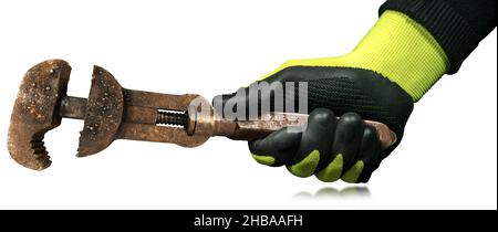 Closeup of a hand with protective work glove holding an old rusty adjustable pipe wrench. Isolated on white background. Stock Photo
