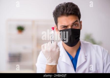 Young biochemist testing blood samples Stock Photo
