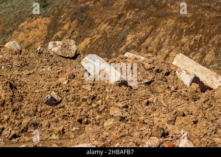 Soil and debris piled up in a heap, discarded concrete blocks Stock Photo