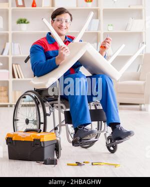 The disabled man repairing chair in workshop Stock Photo