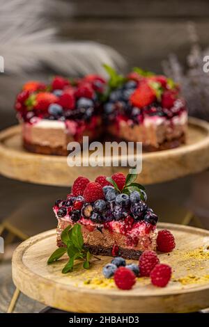 Piece of chocolate cheesecake with berries on top Stock Photo