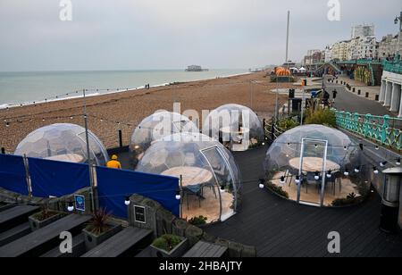 Brighton, UK.  18th December 2021 - Brighton seafront is quiet on an overcast morning as the settled weather is forecast to continue over the next few days in the UK : Credit Simon Dack / Alamy Live News Stock Photo