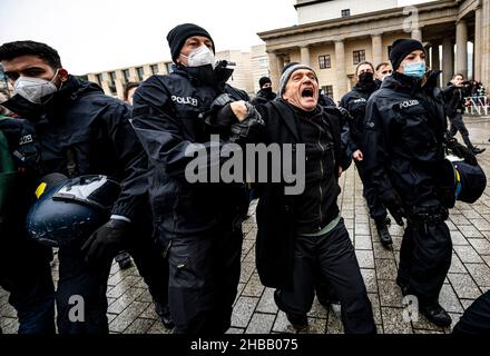 Berlin, Germany. 18th Dec, 2021. The Berlin police takes away a participant of the forbidden demonstration of opponents of Corona rules. The demonstration had been banned by the Berlin police. Credit: Fabian Sommer/dpa/Alamy Live News Stock Photo