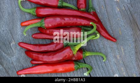 Red Cayenne Peppers on Rustic Wooden Table Background Stock Photo