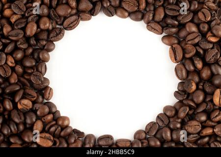 Coffee beans forming circle shape. Top view, close up, place for text. Stock Photo