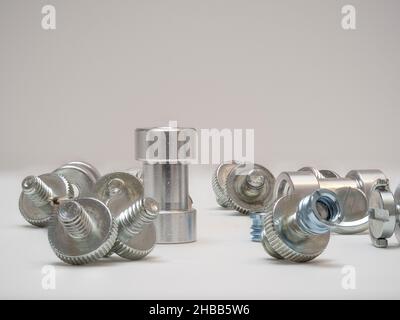CNC machined aluminium bolts with screw threads and a bushing with female connector Stock Photo