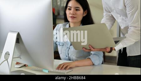 Men and women software developers working together with laptops and computers, Programmers developing new software, Business computer. Stock Photo