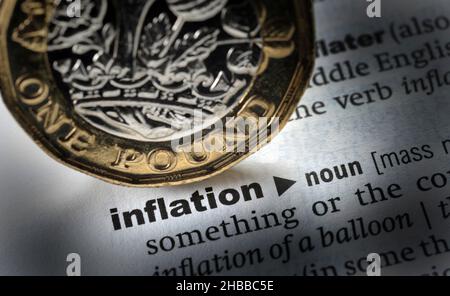 DICTIONARY DEFINITION OF THE WORD INFLATION WITH ONE POUND COIN RE MORTGAGES ECONOMY HOUSEHOLD BILLS ETC UK Stock Photo