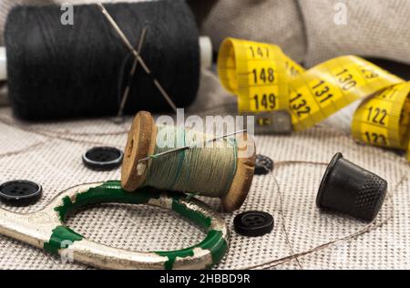 Old vintage sewing accessories. Needle with threads. Scissors. Centimeter.  Thimble Stock Photo - Alamy