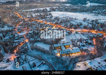 Illuminated Zakopane in Winter. Drone View of Polish Winter Capital City. Stock Photo