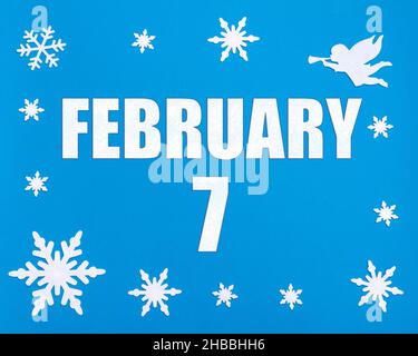 February 7th. Winter blue background with snowflakes, angel and a calendar date. Day 7 of month. Winter month, day of the year concept. Stock Photo