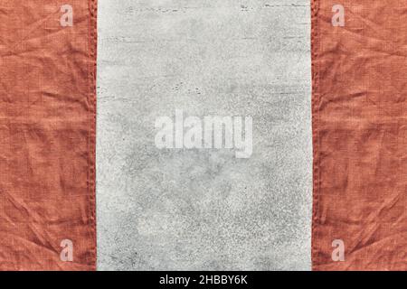 Two folded linen napkins in the form of a frame on a gray background with space for text Stock Photo