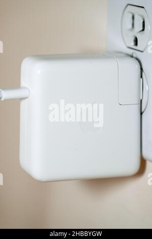 Power supply Electricity plug on brown wooden closeup - Image Stock Photo