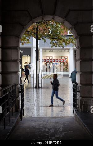 Person Walking in the Rain with an Umbrella, Tunnel Viewpoint Stock Photo