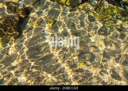 Rocks on the seabed can be seen through the crystal clear seawater Stock Photo
