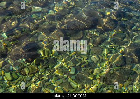 Rocks on the seabed can be seen through the crystal clear seawater Stock Photo