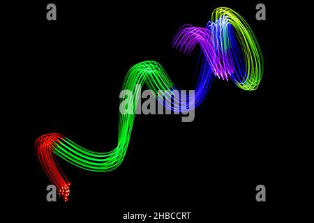 Light Neon Trails Colorful Wave Isolated on black background. Futuristic Colorful Overlay Light Pattern. Stock Photo