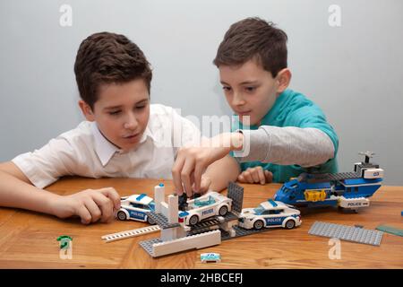 Two boys playing with Lego together Stock Photo