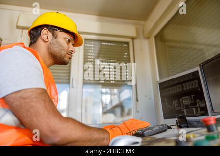 Young construction industry worker is working indoors Stock Photo