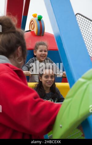 Weymouth Dorset UK 07 30 2018 2 girls enjoying a fair ride in the UK Stock Photo