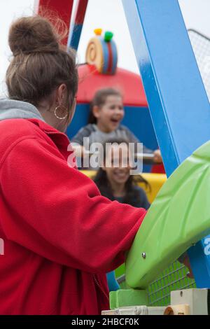 Weymouth Dorset UK 07 30 2018 Two girls enjoying a fair ride in the UK Stock Photo