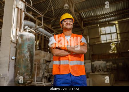 Photo of happy male multiethnic worker in plant Stock Photo