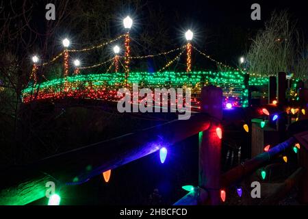 Colorful Christmas lights on Billy Drew Bridge on Clear Creek Trail - Golden, Colorado, USA Stock Photo
