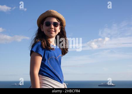 A summer portrait of a girl aged 8 by the Weymouth on Dorset coastline in the UK, taken on the 3rd of August 2020 Stock Photo