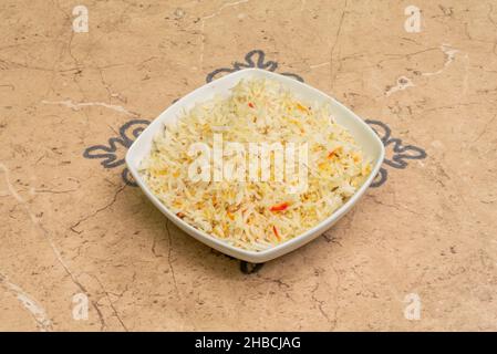 Pilaf, pulaw or pulau is a traditional way of cooking rice, with vegetables, lamb or beef, chicken or sometimes fish, and with spicy seasonings. Stock Photo