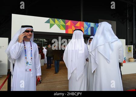 Arab Businessmen Dressed in Traditional Clothing Standing at the Entrance to the Press Conference Hall During UAE Day. Stock Photo