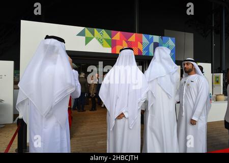 Arab Businessmen Dressed in Islamic Clothing Standing at the Entrance to the Press Conference Hall During UAE Day. Stock Photo