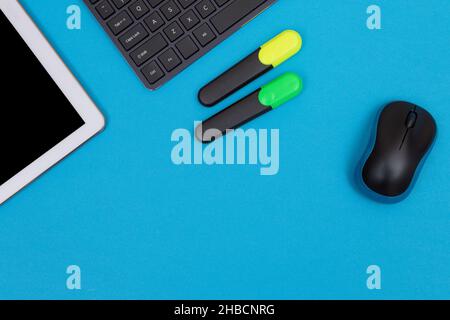 Office Workplace with Digital Gadgets Lying on Blue Table - Flat Lay Stock Photo