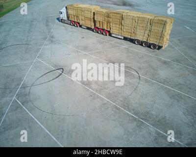 Parked truck with hay bales aerial view at a road site rest stop, near Melbourne, Victoria, Australia. Stock Photo