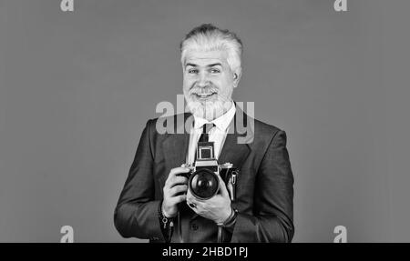 Confident and handsome. professional photographer make photo. male beauty. capture result of barbershop salon. vintage camera. confident businessman Stock Photo
