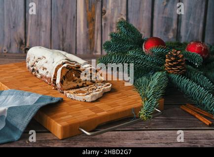 Christmas bread on cutting board decorated with branch and Christmas ornaments Stock Photo