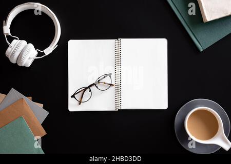 Open blank notebook on black background, flat lay. Stock Photo