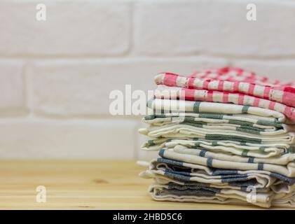 A stack of clean kitchen towels on the table Stock Photo