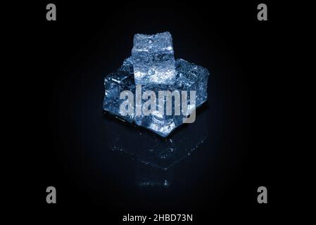 Ice crystal cubes on a black background, space for text or design. Stock Photo
