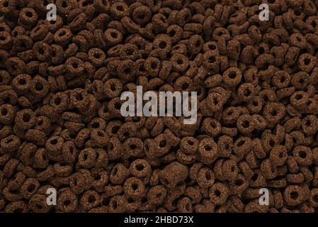 Corn-flakes background and texture. Chocolate rings. Stock Photo