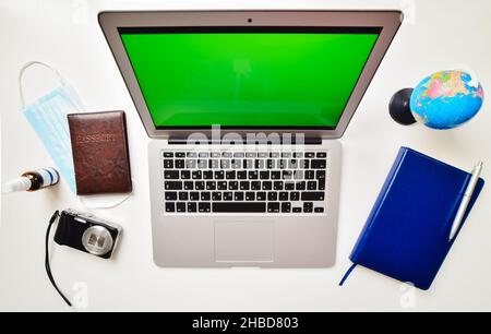Mock up display of laptop on white wooden table for Summer Holiday Vacation background concept. Flat lay top view of Notebook Laptop, camera, global p Stock Photo